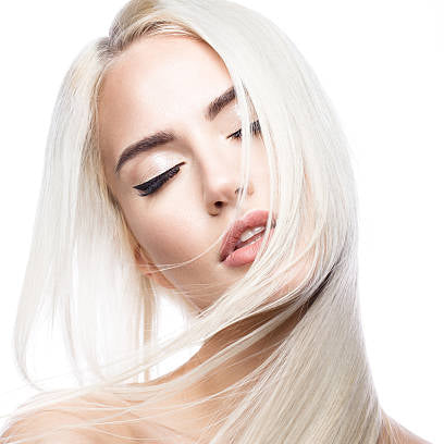 Woman with long, straight blonde hair on a white background